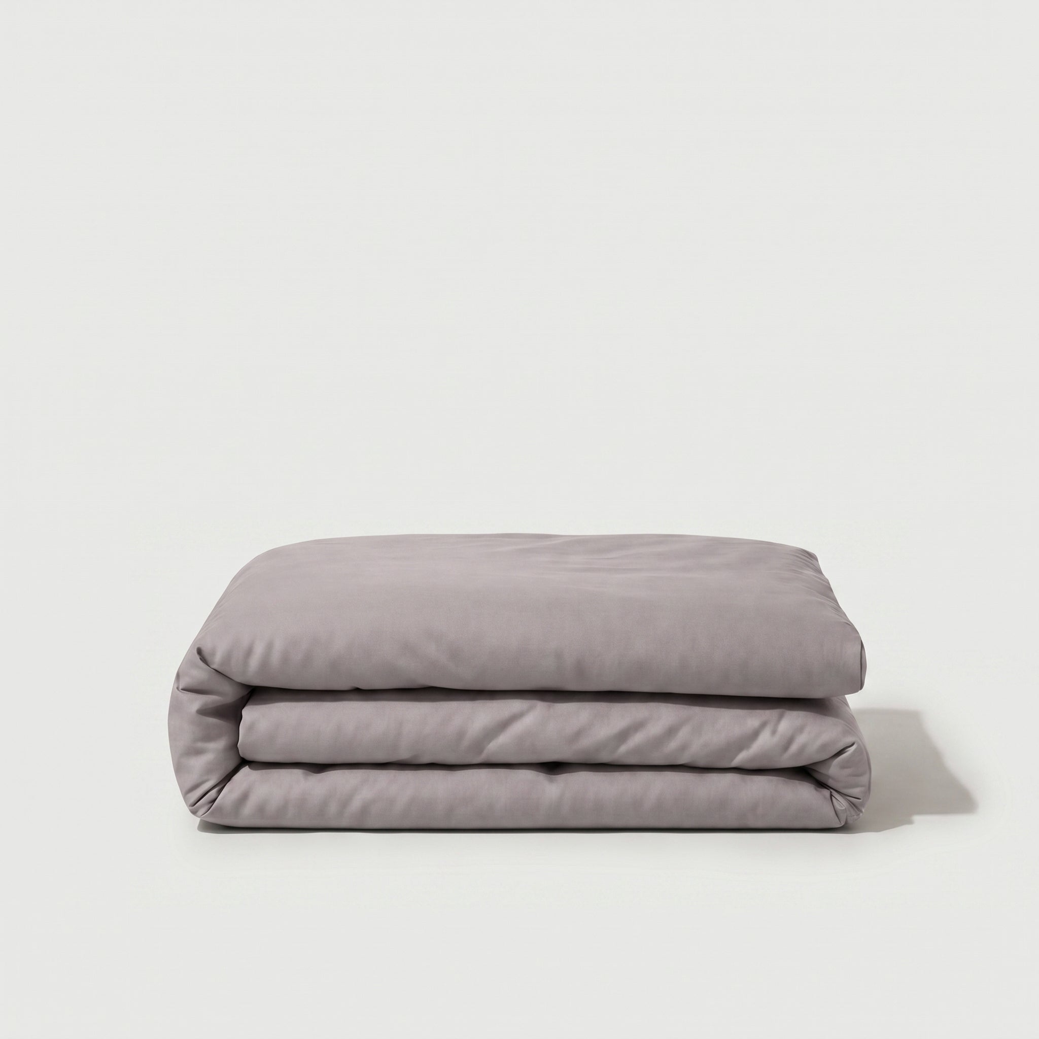 Housse de couette percale de coton unie, texture lisse et respirante, finition élégante et durable.
